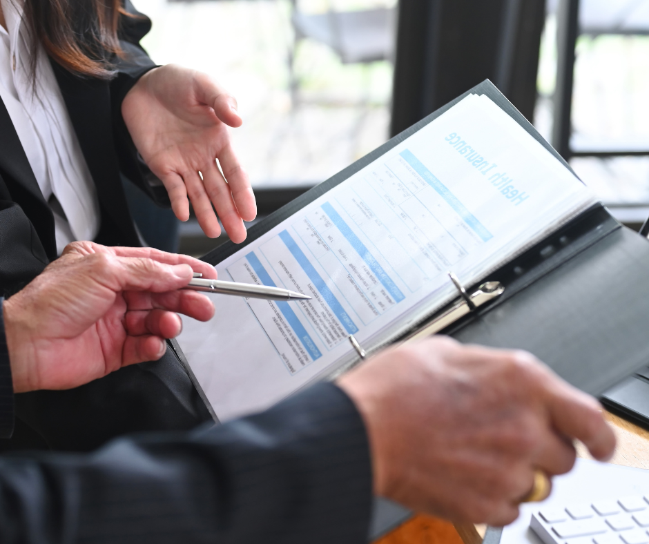 two people looking over business insurance folder